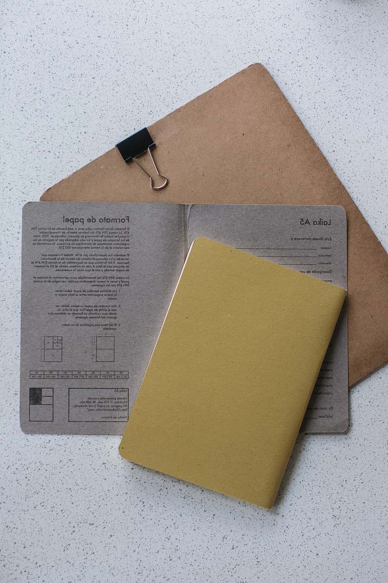 file binder yellow softbound book on grey printer paper file folder